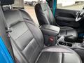 Interior of a 2020 Jeep Wrangler featuring black leather seats with Sahara branding and a center console