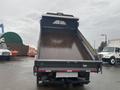 A 2021 Ford F-550 dump truck with an empty bed positioned at an angle showing the interior of the truck bed