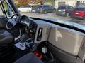 Interior view of a 2013 International DuraStar 4300 truck showing the dashboard steering wheel and gear shifter