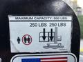A label on a lift showing a maximum capacity of 500 lbs with icons indicating weight limits and safety warnings against exceeding the capacity