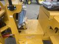2024 AGT KRW 23 Mini loader with a yellow frame featuring controls and a compartment for storage located on the right side