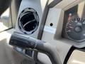 Close-up of the steering column controls in a 2008 Ford F-450 SD showing the turn signal and wiper controls along with the dashboard instrument cluster