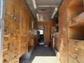 Interior of a 2009 Morgan Olson Workhorse W62 with wooden storage cabinets and a driver’s area visible at the front