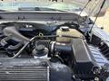 Engine compartment of a 2012 Ford F-450 SD showcasing various components including the air intake the coolant reservoir and the engine cover