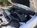 A 2016 Ford F-150 engine bay featuring various components including the air intake system battery and coolant reservoir