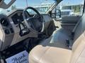 A 2008 Ford F-450 SD interior showcasing the driver's side with beige leather seats and a steering wheel along with a dashboard featuring gauges and controls