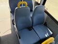 Two blue upholstered seats with black armrests and yellow grab handles, designed for a 2013 Ford Econoline, arranged in a passenger layout