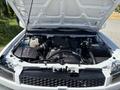 Under the hood of a 2011 Chevrolet Colorado revealing the engine components including the air intake battery and coolant reservoir