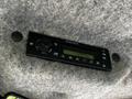A Delphi radio display installed in a vehicle with buttons for tuning and adjusting settings, showing the time as 12:37