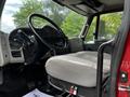 Interior view of a 2011 International 4400 truck showcasing the steering wheel seat and dashboard controls