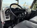 The interior view of a 2011 International 4300 featuring the steering wheel dashboard gauges and leather seats
