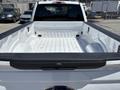 A 2020 Ford F-350 SD pickup truck with an empty bed featuring a white interior and black bed liner details