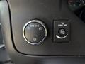 Close-up of the control panel in a 2020 Chevrolet Express featuring knobs for headlight settings and dome light adjustment