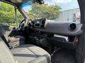 Interior view of a 2021 Mercedes-Benz Sprinter featuring a steering wheel dashboard control panel and seating area