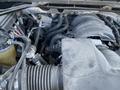 Close-up view of the engine compartment of a 2014 GMC Sierra 1500 showing various components including hoses and wiring