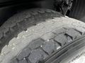A close-up of a tire from a 2012 Freightliner M2 106 showing the tread patterns and texture of the rubber surface