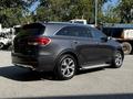 A 2017 Kia Sorento in dark gray with a sleek design featuring silver side steps and alloy wheels parked at an angle