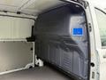 Interior view of a 2020 Mercedes-Benz Metris cargo van showing the wall paneling with a blue safety label