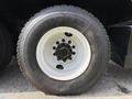 Close-up of a black and white tire from a 1996 Kenworth T800 featuring a multi-bolt hub and the Hercules brand name on the sidewall