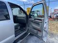 A 2007 Ford F-350 SD with the driver's side door open showing the interior and seating area
