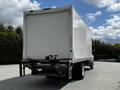 A 2020 Hino 338 truck with a large white cargo box attached at the back and visible rear lights and bumper