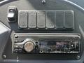 Dashboard of a 2022 Blue Bird BB Conventional featuring a car radio display showing FM and the time 233 with several buttons above the radio