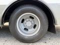 A close-up of a wheel and tire on a 2020 Chevrolet Express featuring a silver rim and a Bridgestone tire with a tread pattern visible