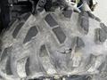 A close-up view of a rugged tire from a 2017 Polaris Scrambler showing a noticeable cut on the surface of the tread