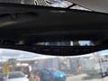 Rearview mirror of a 2016 Ford F-150 featuring control buttons for menu and camera settings