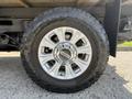Close-up of a silver alloy wheel mounted on a tire of a 2020 Ford F-350 Super Duty featuring a rugged tread pattern and a shiny chrome center cap
