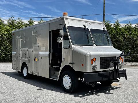 A silver 2008 Morgan Olson Workhorse delivery truck with a flat front two large windows and side doors for access