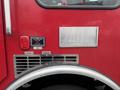 A red 2006 E-One Typhoon fire truck with a silver metal plate and red emergency light on the side