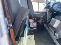 Interior of a 2012 Ford Econoline featuring a driver's seat and a passenger seat with gray fabric upholstery