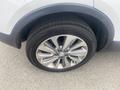 Close-up of the front wheel and tire of a 2018 Buick Encore showcasing a silver alloy rim and a black tire with tread pattern