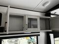 An open cabinet with a metal mesh door in a 2022 Heartland Torque recreational vehicle interior