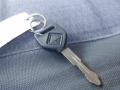 A black key with a circular head and a metal key blade attached to a keyring