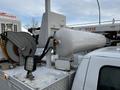 A white 2016 Ford F-550 with a large cylindrical tank mounted on the rear and a hose reel beside it