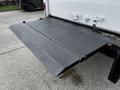 A black diamond plate liftgate extended from the back of a 2006 Hino 268 truck making it easy to load and unload cargo