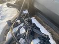 Close-up of a 2000 plow with a 12-foot attachment featuring hydraulic hoses chains and a robust mounting mechanism