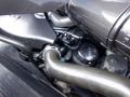 Close-up view of the engine components of a 2016 Mercedes-Benz Sprinter including pipes and caps