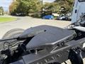 Close-up of a black fifth wheel hitch mounted on a 2003 Freightliner M2 106 truck chassis