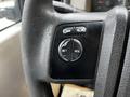 Steering wheel controls of a 2009 Ford F-550 showing buttons for setting and resuming cruise control