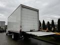 A 2018 Freightliner M2 106 with a large white box cargo area and a rear loading ramp