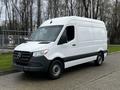 A white 2021 Mercedes-Benz Sprinter van with a plain exterior and black accents parked on a pavement