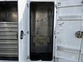 A 2018 Ford F-550 service truck with an open storage compartment revealing a metal interior and no shelves or equipment inside