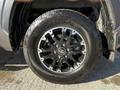 Close-up of a black alloy wheel with silver accents mounted on a tire featuring the Michelin brand logo