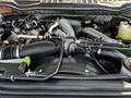 A close-up view of the engine compartment of a 2021 Ford F-550 showing various components including hoses and tubing around the engine block