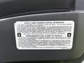 A sticker with vehicle noise emission control information attached to the interior of a 2016 Isuzu NQR truck