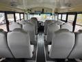 Interior view of a 2016 International CE300 school bus featuring multiple rows of gray, high-backed seats arranged in a clean layout