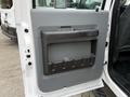 The image shows the interior door panel of a 2013 Ford F-550 featuring a gray plastic design with a built-in storage compartment and handle